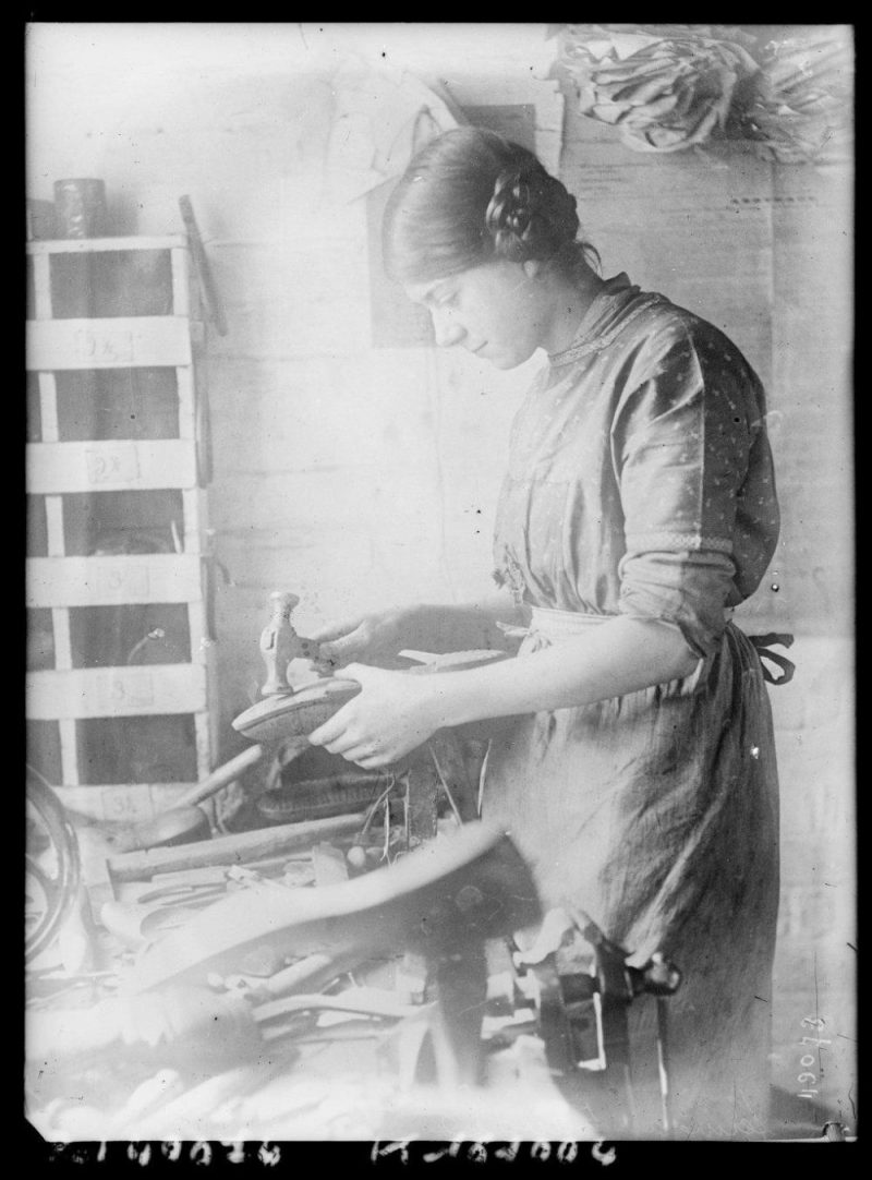 Woman making or repairing shoes