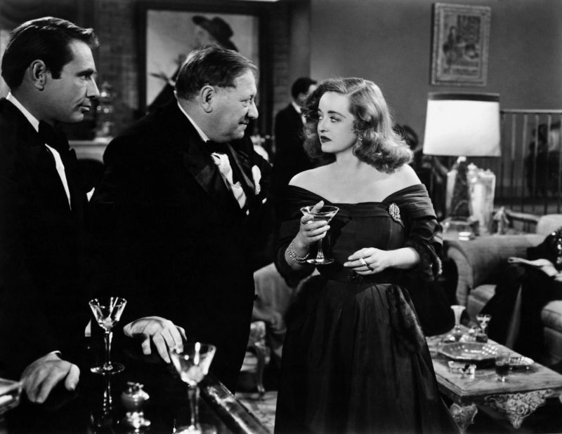 1950: A scene from the film 'All About Eve', starring Gregory Ratoff (1897 - 1960), Gary Merrill (1914 - 1990) and Bette Davis (1908 - 1989). The film was directed by Joseph L Mankiewicz for 20th Century Fox.