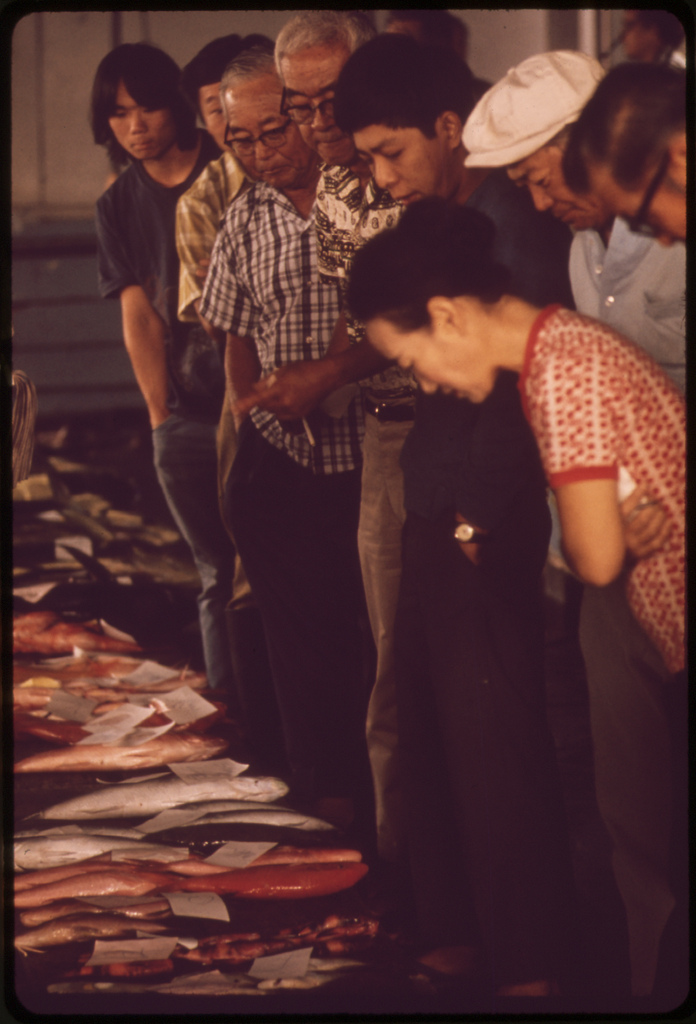 Customers looking over the day's assortment at the Hilo fish auction, a daily event, November 1973