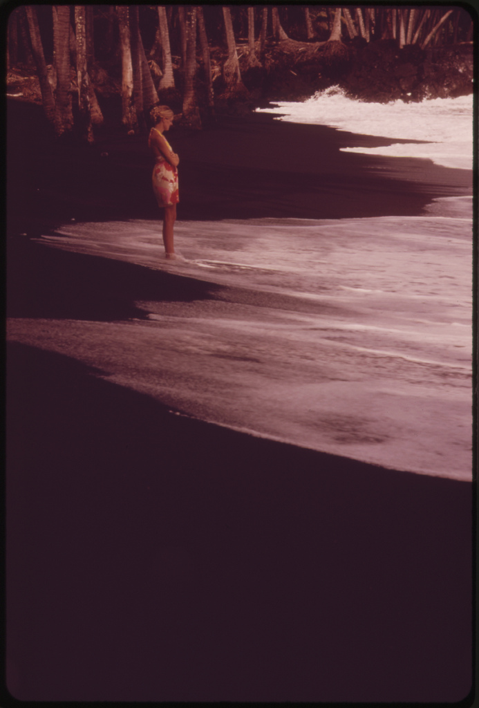 Famous Black Sand Beach at Kaimu, created by lava runoff, is a favorite tourist stop, November 1973