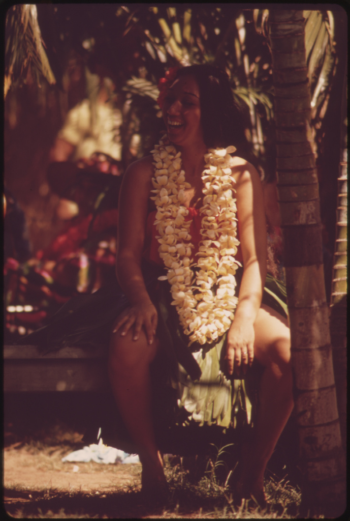 Hawaiian rests after demonstrating hula dance to appreciative Waikiki Beach tourists, October 1973
