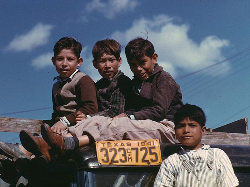Boys sitting on truck parked at the FSA labor camp, Robston, Texas