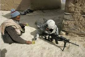 An Afghan man offers tea to thirsty fighting American soldiers