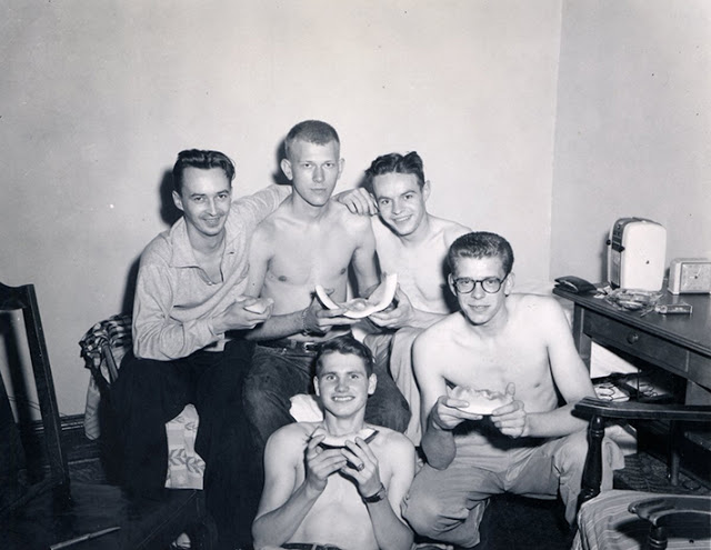 Just a bunch of guys hanging out, eating melon, ca. 1950s.