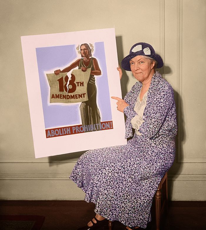 Woman holds poster that reads; Abolish Prohibition!