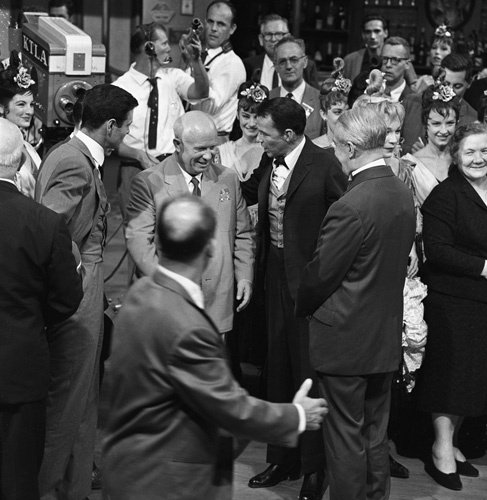 Shirley MacLaine, Frank Sinatra, Louis Jordan and cast play host to visiting Soviet Premier Nikita Khrushchev on the set of Can-Can (1960).