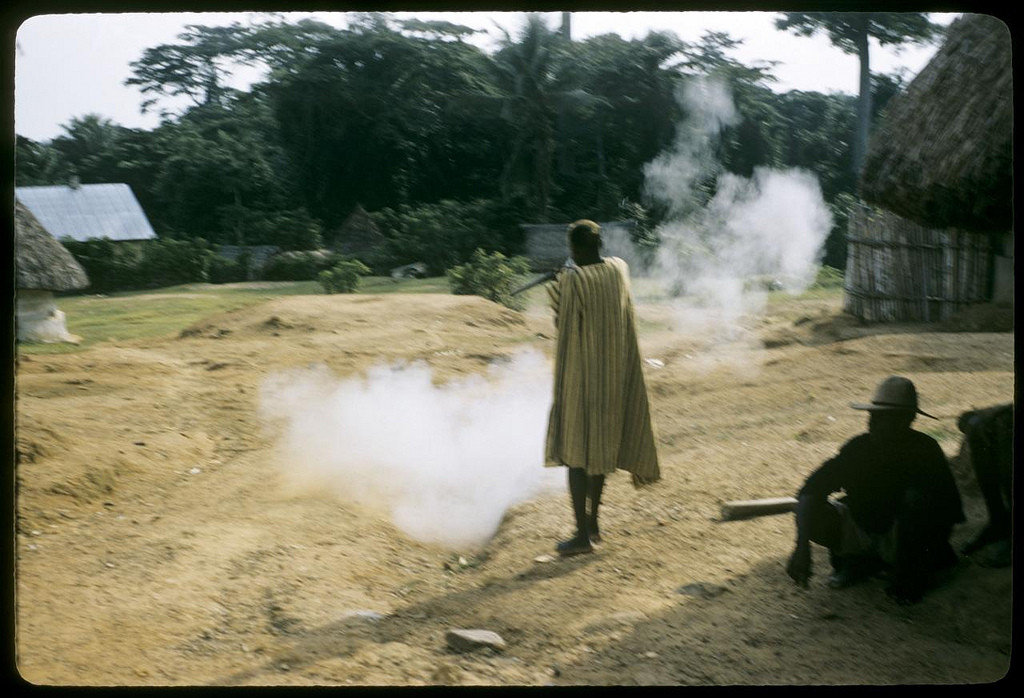 Firing shotgun to celebrate boys coming out of bush school, 1958. William Gotwald Liberia mission slides, 1957-1960. ELCA Archives scan. http://www.elca.org/archives