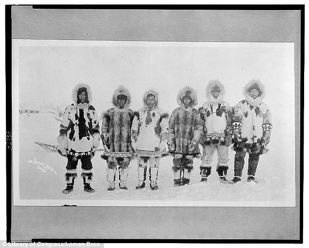 A line of Eskimo men are pictured between 1900 and 1930 while wearing various shades and patterns of animal furs as protection. Library of Congres. Lomen bros