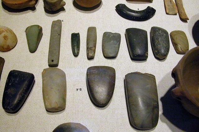 Neolithic artifacts, including bracelets, axe heads, chisels, and polishing tools.