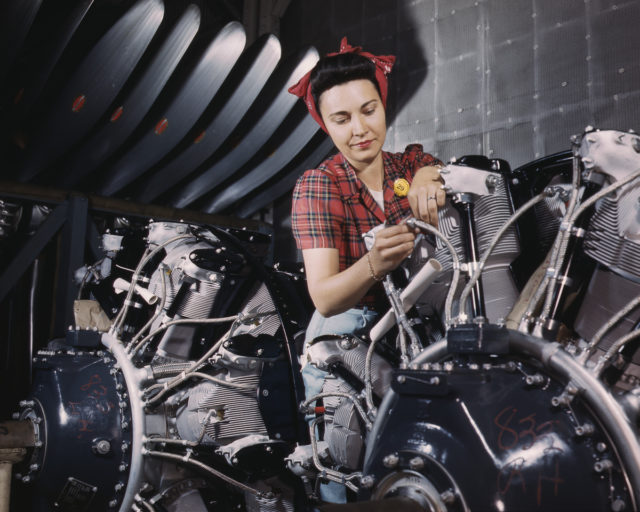 A worker adjusts an airplane motor at the North American Aviation plant in Inglewood, California.