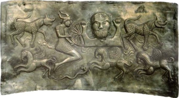 Plate C of the Gundestrup cauldron, showing a man in a horned helmet holding a wheel.Source