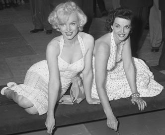 Marilyn Monroe and Jane Russell putting signatures in wet concrete at Chinese Theater in Los Angeles, Calif., 1953 Source