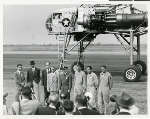 Howard Hughes (second from left) standing under the blade of the XH-17, Flying Crane with L-R: Rea Hopper, Director of the Aeronautical Division, Hughes Aircraft Company; Hughes; Clyde Jones, Director of Engineering, Hughes Tool Company Aeronautical Division; Warren Reed, Assistant; Colonel Carl E. Jackson, Air Research and Development Headquarters; Gale. J. Moore, Pilot; Chal Bowen?, Flight Engineer/Co-Pilot; unidentified pilot. source
