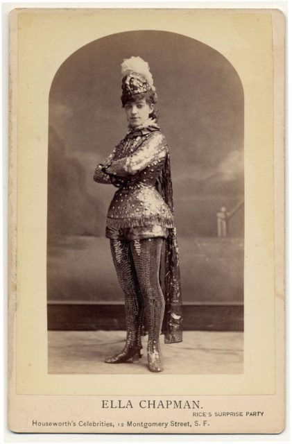 Ella Chapman in short metallic armor costume, including leggings, helmet with feather. Rice's surprise party.