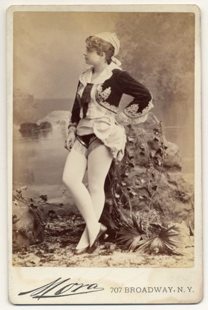 Pauline Hall in a short, Greek style costume, flat shoes.