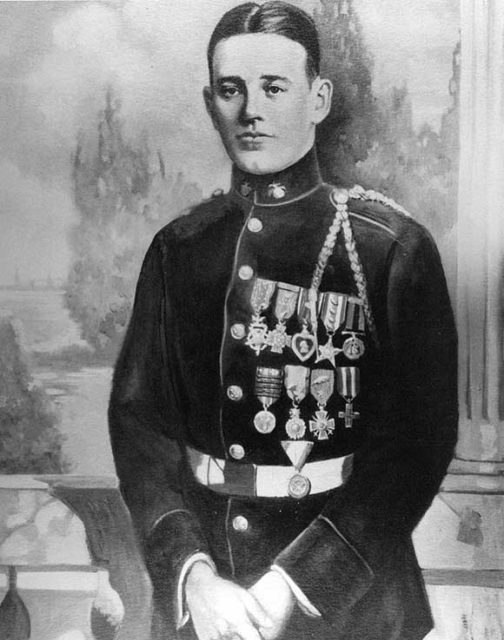 Portrait of Pvt. Kelly wearing all of his medals. Source