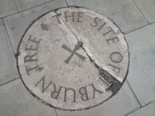 Stone marking the site of the Tyburn tree on the traffic island at the junction of Edgware Road, Marble Arch and Oxford Street. Source