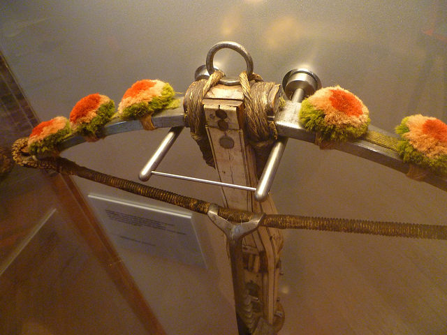 Cross-bow with pieces of flair on display at the Arms Museum. Source