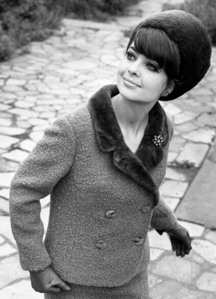 Fashion model from Leipzig, GDR wearing a wool suit trimmed with fur and a matching fur hat, 1966.Source