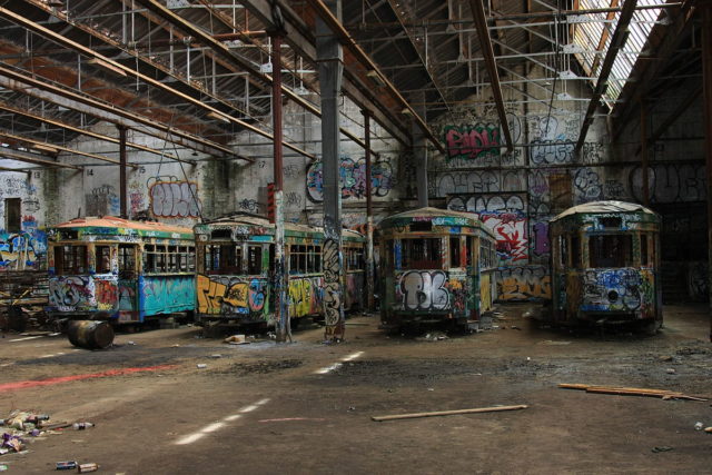 Heavily vandalized trams in the abandoned Rozelle tram depot. Source