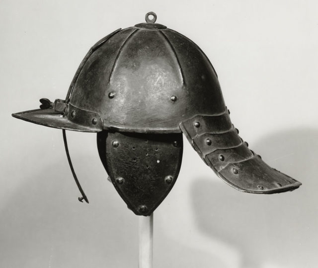 Lobster-tailed pot helmet. This example has a single sliding nasal bar and fixed peak to protect the face, Dutch mid-17th century Source