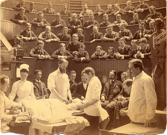 Surgeon administers ether and Dr. Cheever operates on patient in Sears Building amphitheater, 1880-1900