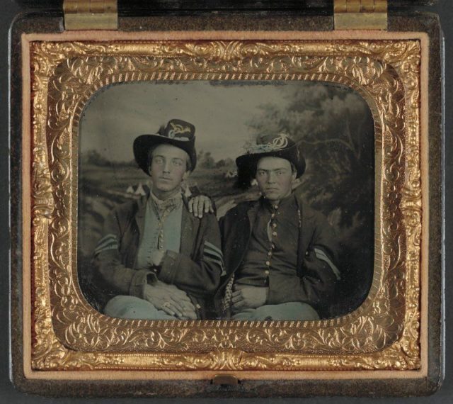Unidentified sergeant and corporal in Union uniforms in front of painted backdrop