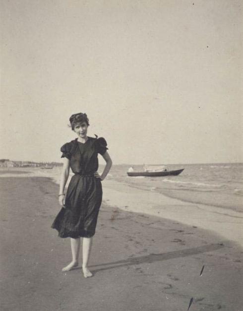 Woman on beach 1900s Source
