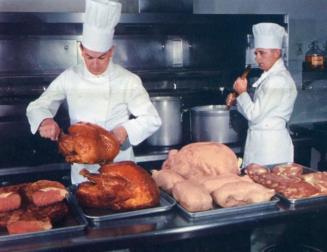 Caterers prepare turkeys to be served on board.