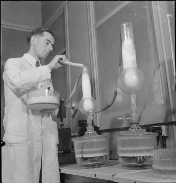 A laboratory worker in 1943 measures purified penicillin into ampoules or bottles. Source