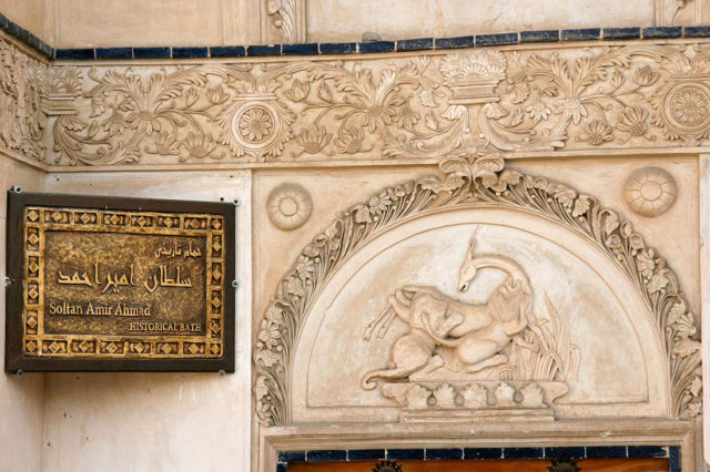 Stone relief above the entrance door. Source