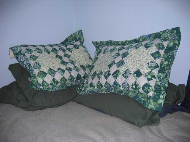 Decorated pillows piled on the corner of a bed Source: Wikipedia/Public Domain