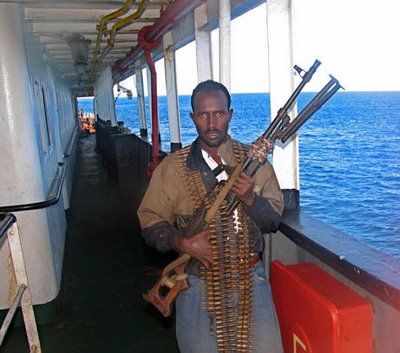 A Somali pirate with weapons aboard a vessel