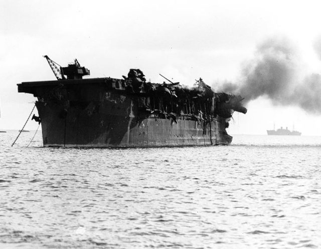 USS Independence is on fire aft following the Operation Crossroads shot Able atomic bomb test, 1 July 1946