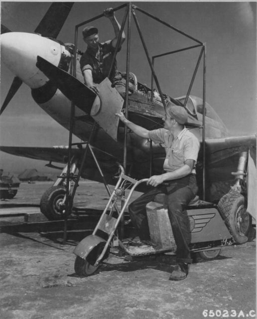 Total field mod. When your job is servicing the P-51s stationed on Iwo Jima, a motor scooter built from fuselage panels and cowling comes in handy. Notice the logo of North American Aviation on the scooter’s side. (NARA)