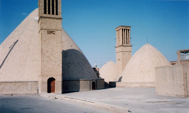 An ab anbar (water reservoir) with double domes and windcatchers (openings near the top of the towers) in the central desert city of Naeen, Iran. Photo Credit