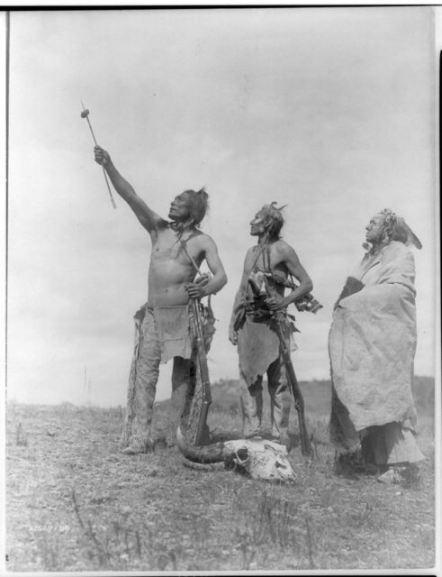 Crow Indians offering food -Edward S. Curtis