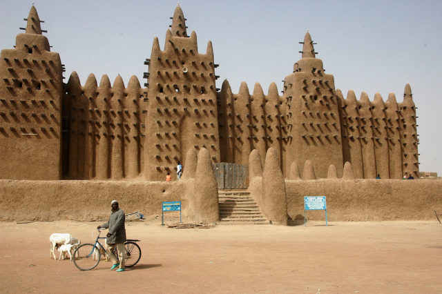 The Great Mosque's signature trio of minarets overlooks the central market of Djenné. Photo Credit
