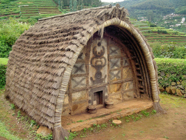 The hut of a Toda Tribe of Nilgiris, India. Note the decoration of the front wall, and the very small door. Photo Credit