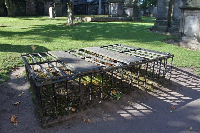 There were many types of these mortsafes, ranging from iron cages to heavy stone table tombstones or concrete boxes. Photo Credit