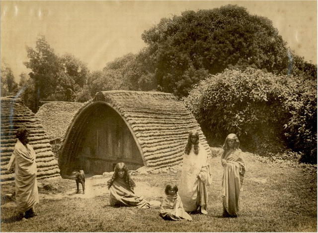 Toda people in front of their hut in the Nilgiri Hills.