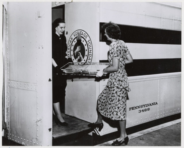 Photograph of National Archives Employees Peggy Mangum and Florence Nichol Loading the Log of the Frigate Constitution onto the Freedom Train
