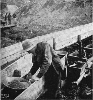 Taking gold out of a sluice box, western North America, 1900s