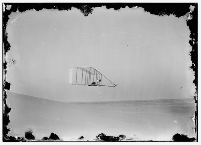 Side view of Wilbur gliding in level flight, moving to right near bottom of Big Hill Photo Credit 