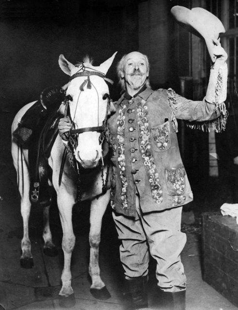 Photo of Buffalo Bill and his horse taking a bow after a 1915 performance. . Photo Credit 