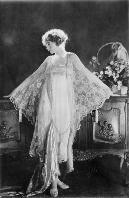 illian Gish, full-length portrait, standing, facing left, wearing pink morning gown of chiffon and lace Photo Credit 