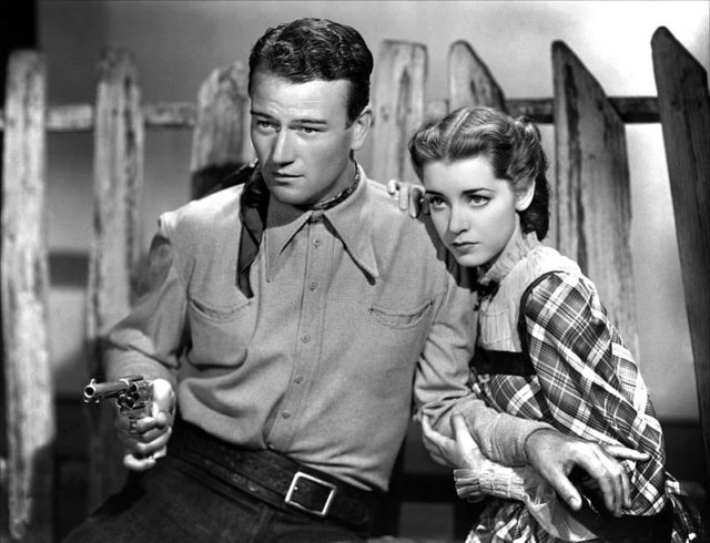 John Wayne with Marsha Hunt in Born to the West (1937).