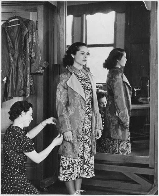 NYA-San Jose California-dressmaking experience in sewing costumes for school play-young woman standing by mirror Photo Credit