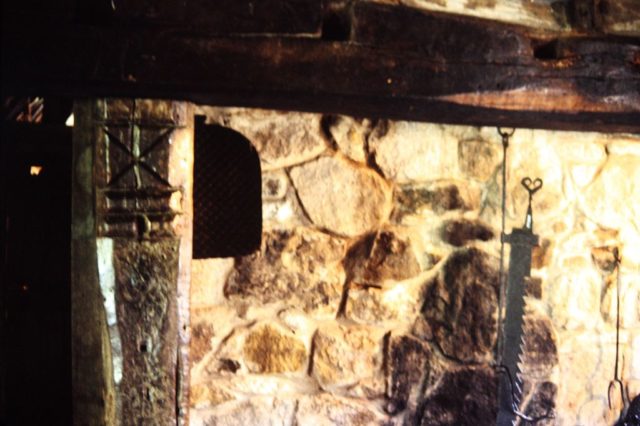 Traditional stone fireplace in northern England. The carved St. Andrew's cross in the left hand wooden post was to prevent witches from flying down the chimney, Ryedale Folk Museum, Hutton-le-Hole. Photo credit