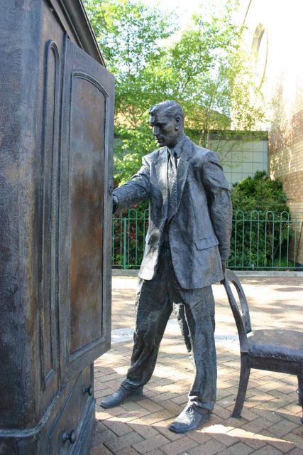 Statue of C. S. Lewis looking into a wardrobe. Photo Credit